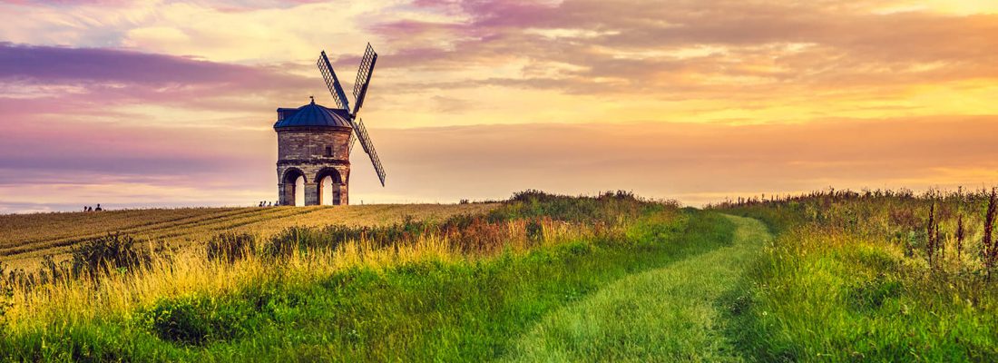 A windmill in front of a sunset