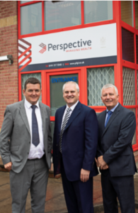 A picture of three people outside of a Perspective office