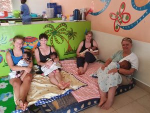 An image of women sitting with babies