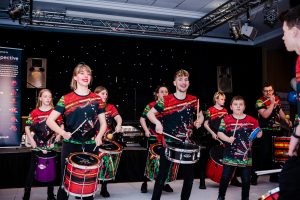 An image of a band playing the drums.