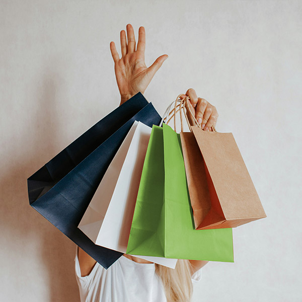 Person holding up paper bags